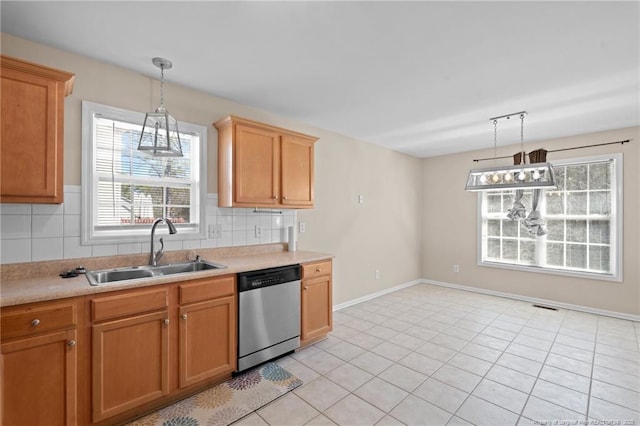 kitchen with a sink, visible vents, light countertops, and dishwasher