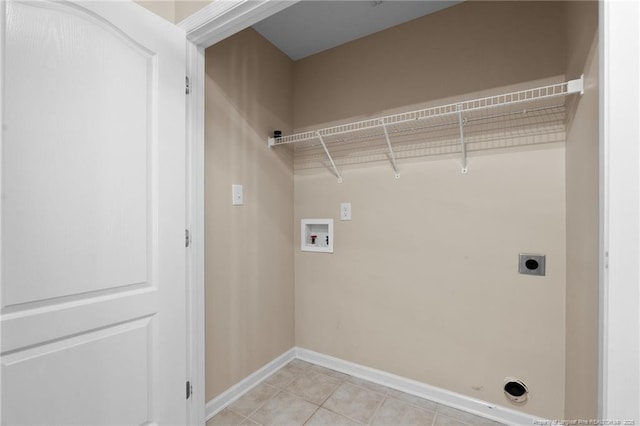 clothes washing area with light tile patterned floors, hookup for an electric dryer, laundry area, washer hookup, and baseboards