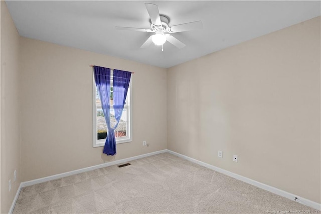 empty room with light carpet, baseboards, visible vents, and ceiling fan