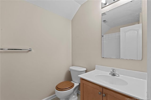 bathroom with visible vents, baseboards, lofted ceiling, toilet, and vanity