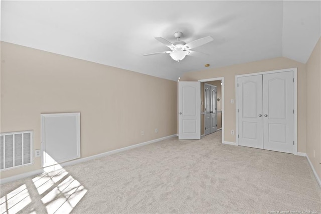 unfurnished bedroom with light carpet, a closet, visible vents, and baseboards