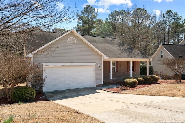 single story home with a garage, concrete driveway, brick siding, and covered porch