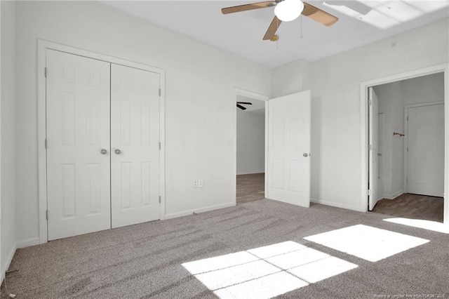 unfurnished bedroom with carpet floors, a closet, ceiling fan, and baseboards