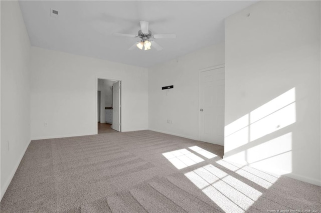 spare room featuring a ceiling fan, carpet flooring, visible vents, and baseboards