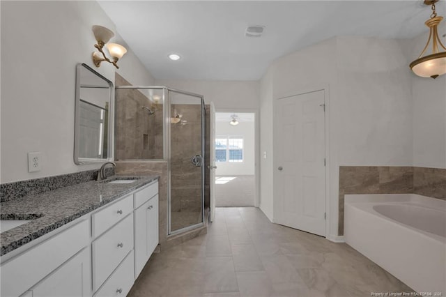 full bath with a sink, a shower stall, double vanity, and a bath