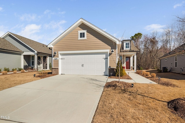 traditional-style home with central AC, an attached garage, brick siding, and driveway