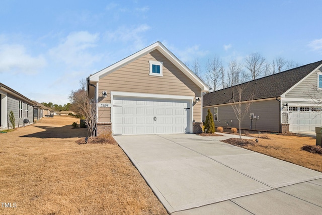 view of home's exterior featuring concrete driveway, a garage, brick siding, and a yard