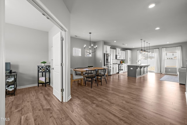 350 Arlie Ln, Lillington, NC 27546 - dining area featuring a chandelier, dark wood-style flooring, plenty of natural light, recessed lighting, and baseboards
