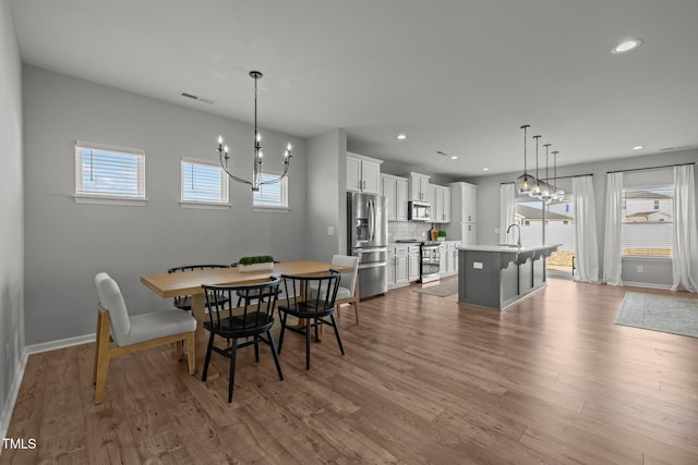 350 Arlie Ln, Lillington, NC 27546 - dining room featuring a chandelier, wood finished floors, baseboards, and recessed lighting
