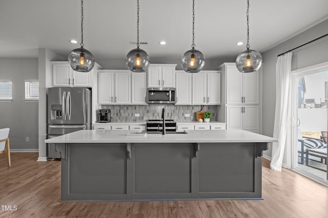 350 Arlie Ln, Lillington, NC 27546 - kitchen featuring stainless steel appliances, a sink, recessed lighting, light countertops, and baseboards