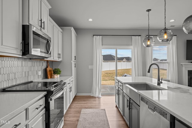 350 Arlie Ln, Lillington, NC 27546 - kitchen with stainless steel appliances, a sink, light countertops, backsplash, and recessed lighting