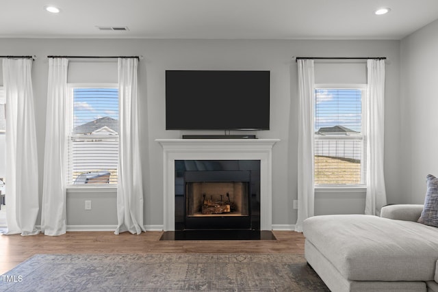 350 Arlie Ln, Lillington, NC 27546 - living area featuring a fireplace with flush hearth, wood finished floors, recessed lighting, healthy amount of natural light, and baseboards