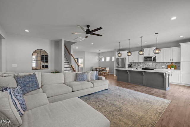 350 Arlie Ln, Lillington, NC 27546 - living room with light wood-style flooring, a chandelier, recessed lighting, ceiling fan, and stairway