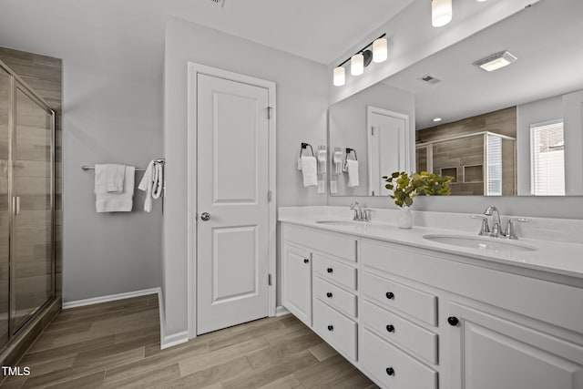 350 Arlie Ln, Lillington, NC 27546 - bathroom with double vanity, a stall shower, wood finished floors, and baseboards