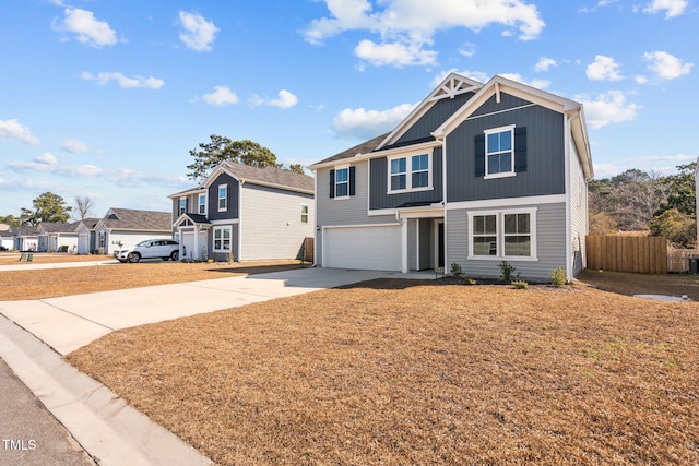 view of front of property with a garage, fence, driveway, a residential view, and board and batten siding