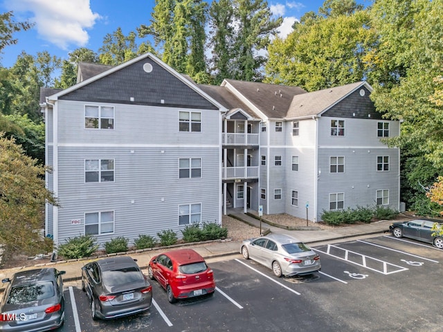 view of building exterior with uncovered parking