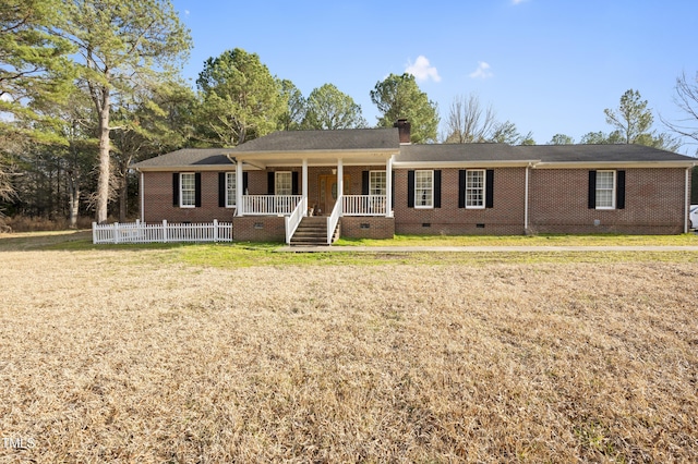 single story home with brick siding, a chimney, a porch, crawl space, and a front lawn