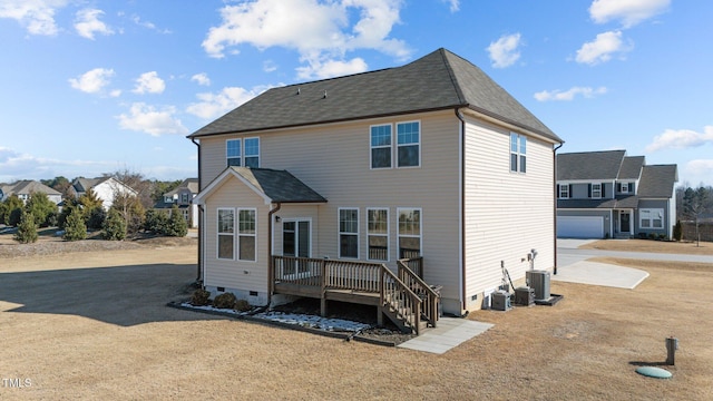 back of house with crawl space, a garage, a deck, and cooling unit