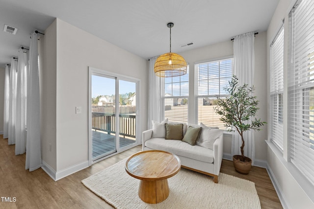 interior space with light wood-style flooring, plenty of natural light, and visible vents