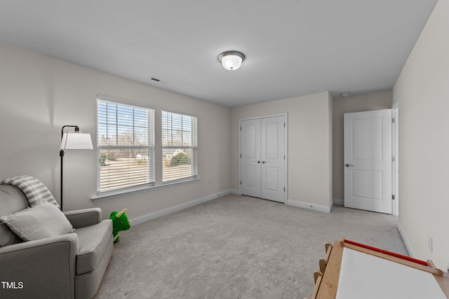 sitting room with light carpet, baseboards, and visible vents