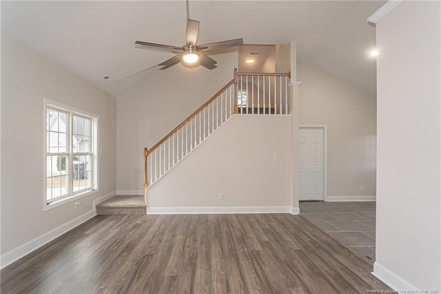 unfurnished living room with baseboards, a ceiling fan, wood finished floors, stairs, and high vaulted ceiling