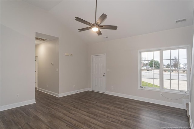 empty room with lofted ceiling, baseboards, visible vents, and dark wood-style flooring