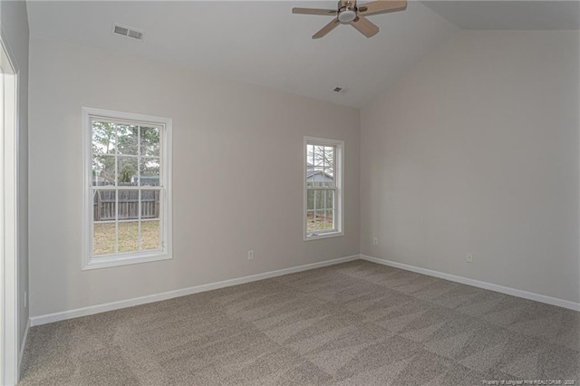 carpeted spare room featuring lofted ceiling, baseboards, visible vents, and ceiling fan