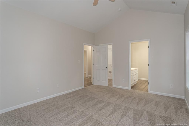 unfurnished bedroom with visible vents, baseboards, ensuite bathroom, vaulted ceiling, and carpet flooring