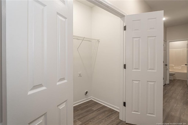 washroom featuring laundry area, baseboards, electric dryer hookup, and dark wood-style flooring