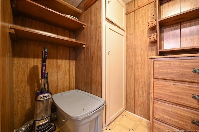 mudroom with light floors and wooden walls