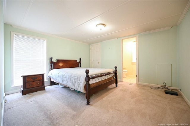 carpeted bedroom featuring baseboards, connected bathroom, and ornamental molding