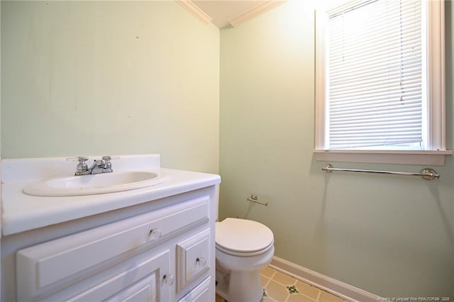 bathroom with baseboards, crown molding, vanity, and toilet