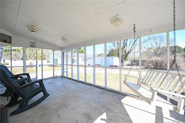 unfurnished sunroom featuring a water view