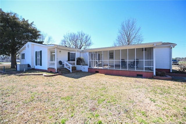 view of front of property with crawl space, a front yard, and a sunroom