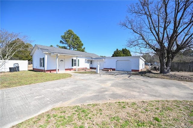 single story home featuring an outbuilding, fence, driveway, and a front lawn