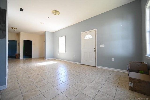 entryway featuring light tile patterned floors and baseboards