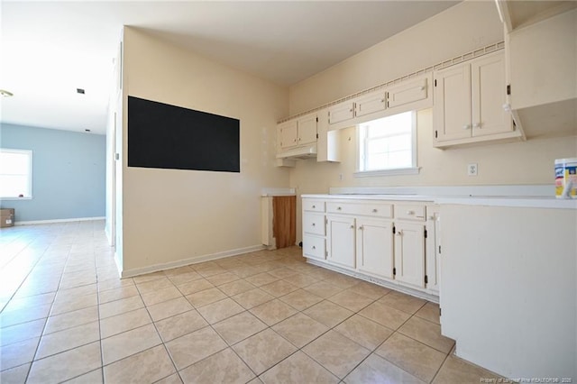 kitchen featuring light tile patterned floors, white cabinets, and light countertops