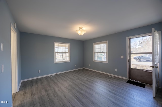 interior space with wood finished floors and baseboards