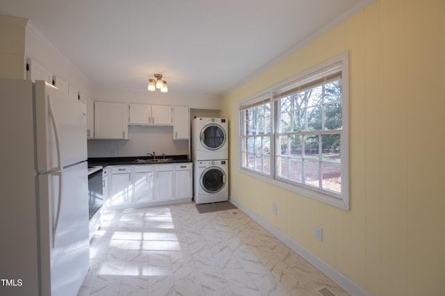 laundry room with laundry area, stacked washer / dryer, marble finish floor, crown molding, and a sink