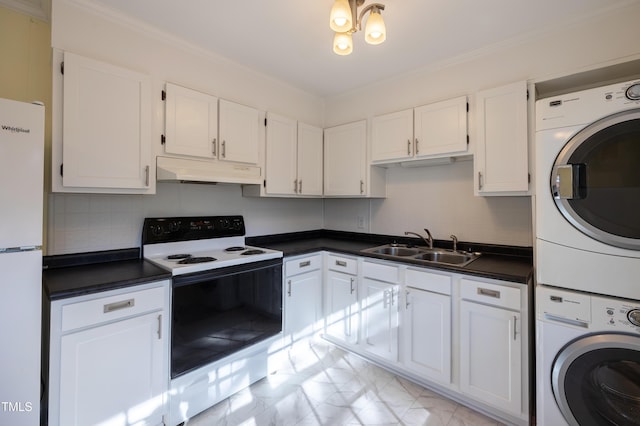 kitchen with under cabinet range hood, a sink, stacked washer / drying machine, freestanding refrigerator, and electric range oven