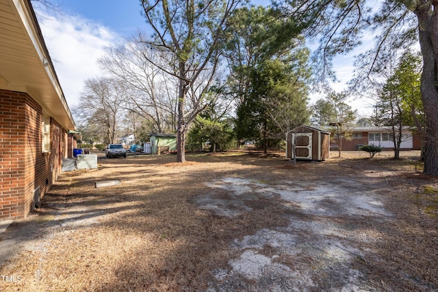 view of yard featuring a storage shed and an outbuilding