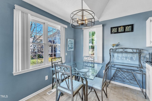 dining space with lofted ceiling, visible vents, a chandelier, tile patterned flooring, and baseboards