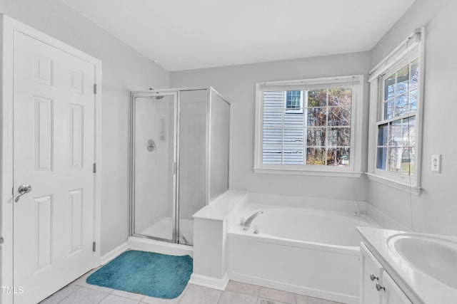 full bathroom featuring a stall shower, a garden tub, vanity, and tile patterned floors