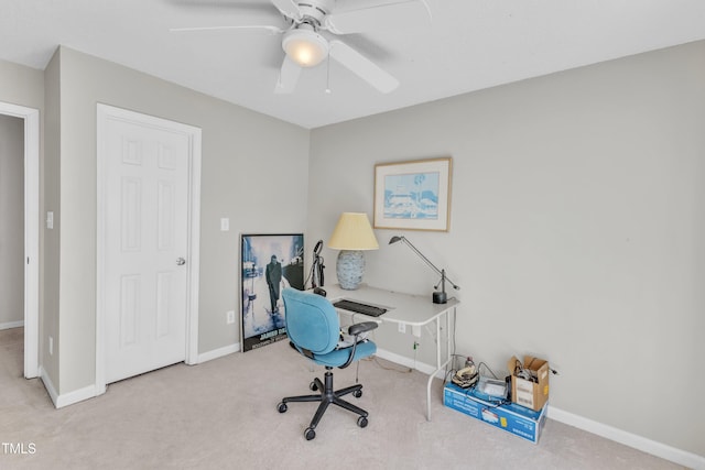 office area featuring carpet flooring, ceiling fan, and baseboards