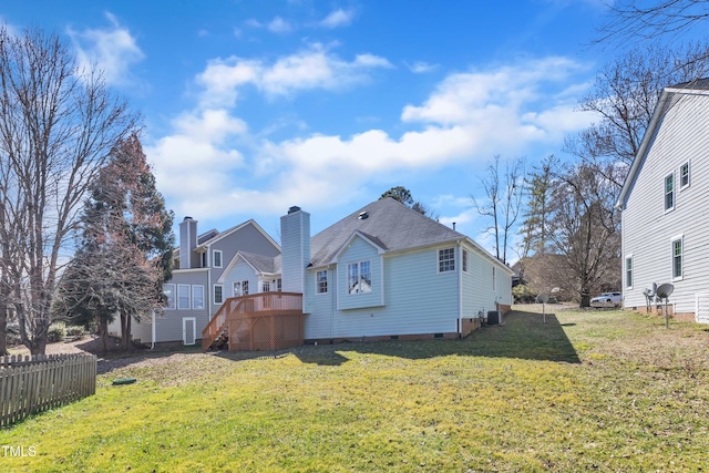 rear view of property featuring roof with shingles, fence, cooling unit, and a yard