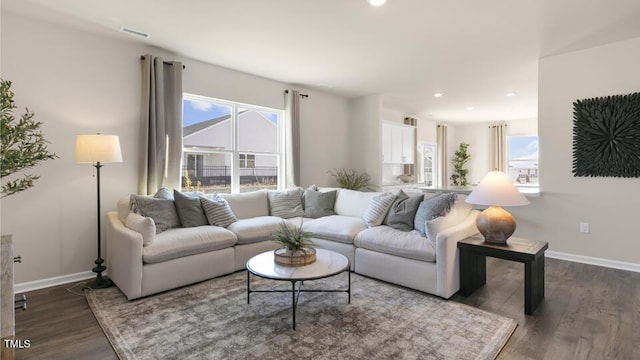 150 Ethel Ln, Angier, NC 27501 - living area featuring healthy amount of natural light, baseboards, dark wood-type flooring, and recessed lighting