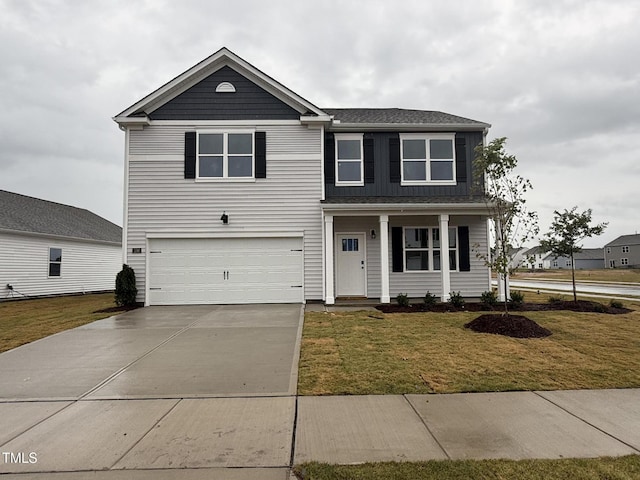 150 Ethel Ln, Angier, NC 27501 - traditional-style home featuring an attached garage, concrete driveway, a front lawn, a porch, and a shingled roof