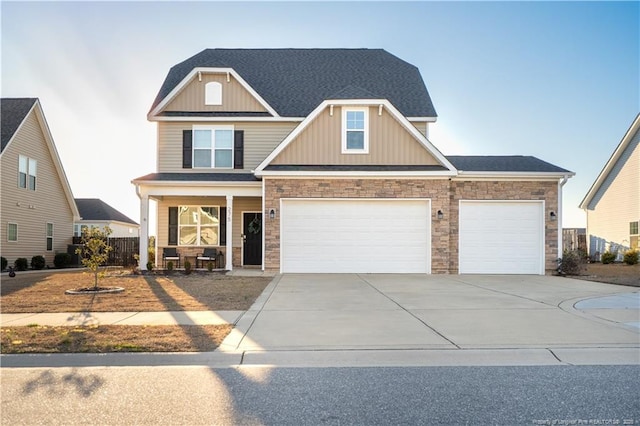 craftsman house with roof with shingles, a porch, concrete driveway, board and batten siding, and stone siding