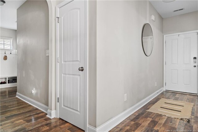 entryway with visible vents, baseboards, and wood finished floors