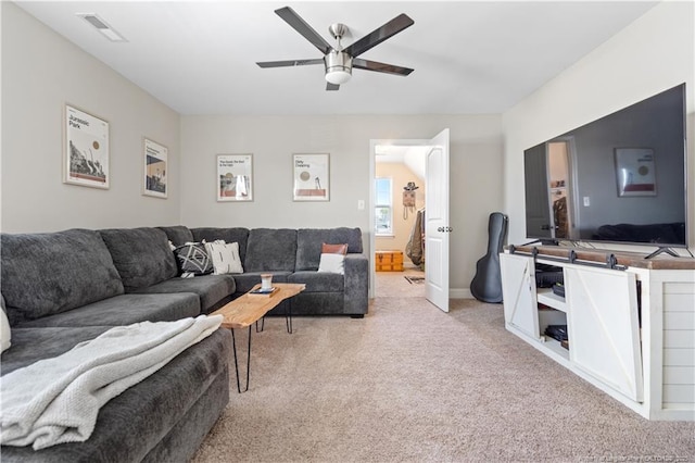 carpeted living room with ceiling fan and visible vents